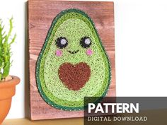 an avocado is featured on a wood block with a plant in the background