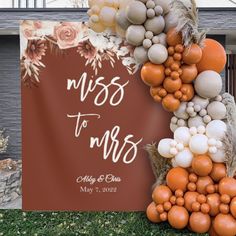 an orange and white wedding sign with balloons attached to the back of it that says, miss to mrs