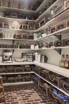 an organized pantry with lots of wooden crates and boxes on the shelves, along with other items