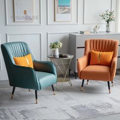 two colorful chairs sitting next to each other in front of a wall with pictures on it