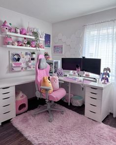 a child's bedroom with pink furniture and accessories on the desk, along with stuffed animals