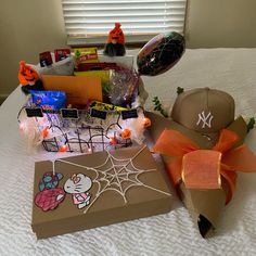 a bed topped with boxes filled with candy and other items sitting on top of it