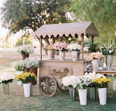 an old fashioned ice cream cart with flowers on display