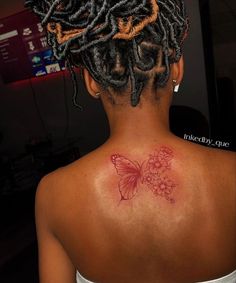 a woman with a butterfly tattoo on her back