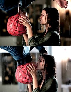 spider - man and woman kissing in the rain, with one being kissed by another