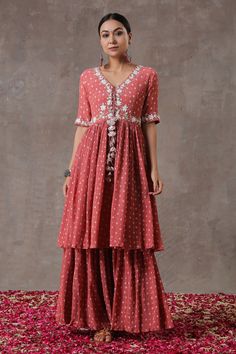 Peach flared kurta with block printed motifs and pearl embroidery. Comes with gharara and organza.
Component: 3
Pattern: Print and Embroidery
Type Of Work: Block Print and Pearl
Neckline: V neck
Sleeve Type: Half
Fabric: Crinkled Cotton Silk and Organza
Color: Peach
Other Details: 
Dupatta with scalloped border
Tie up at the neckline
Elasticated waistband
Occasion: Puja - Aza Fashions Diwali Anarkali Palazzo Set With Ruffles, Anarkali Palazzo Set With Ruffles For Festivals, Bohemian Floor-length Sharara With Gota Work, Bohemian Ruffled Sharara For Festive Occasions, Bohemian Maxi Length Sharara For Wedding, Festive Bohemian Ruffled Sharara, Festive Anarkali Palazzo Set With Ruffles, Bohemian Festive Sharara With Ruffles, Anarkali Ruffled Sharara For Festivals