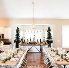 a dining room table is set up with place settings for the holiday meal and decorations