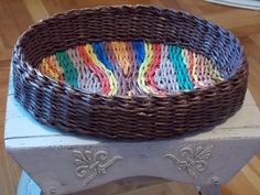 a wicker basket sitting on top of a wooden table