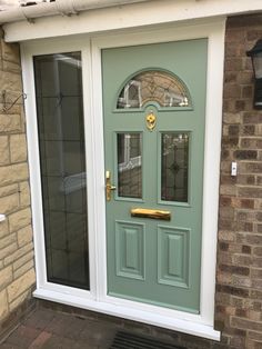 a green front door on a brick building