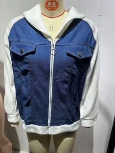 a mannequin wearing a blue jean jacket with white hoodie and zippers