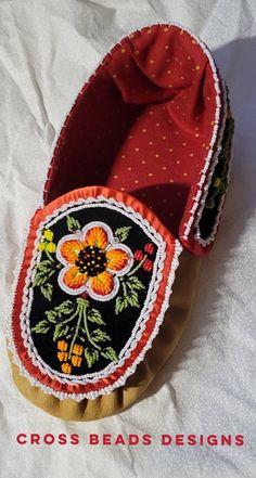 a pair of red shoes sitting on top of a white sheet