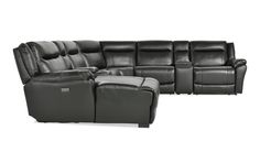 a black leather sectional sofa with recliners and ottomans on the bottom left side