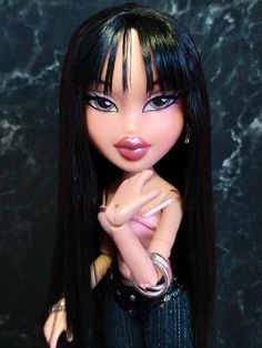 a close up of a doll with long black hair