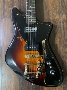 an electric guitar sitting on top of a wooden floor