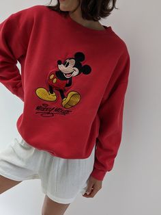 Vintage 90s nostalgic perfectly worn in Mickey Mouse pullover features a round neckline with micro ribbed detailing and an embroidered Mickey Mouse logo on the front. Perfectly paired with our waffled cotton shorts, your favorite ball cap, new balances, and your gold-toned jewelry. Tag reads Mickey Inc Subtle spots of lightening at the front middle. Vintage Disney Crewneck, Old Money Disney Outfits, Chic Disneyland Outfits, Classic Disney Aesthetic, 90s Crew Neck Top With Embroidered Logo, 90s Style Winter Tops With Embroidered Logo, Trendy Embroidered Logo Tops For Loungewear, Vintage Ribbed Cuffs Top For Spring, Vintage Tops With Ribbed Cuffs For Spring