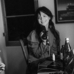 black and white photograph of two women sitting at a table with laptops in front of them