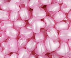 pink heart shaped plastic beads are shown in this image