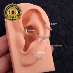 an image of a fake ear that is being held up to show the size and width