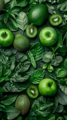 green apples and kiwis surrounded by leaves