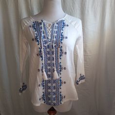 Lucky Brand White Long Sleeve Lace Up Peasant Top With Black And Blue Embroidery Down The Center And On Sleeves Size Xs But Runs Large, See Photos For Measurements New With Tags White V-neck Shirt With Floral Embroidery, White Embroidered V-neck Shirt, Bohemian Tunics, Cotton Tunic Tops, Boho Tunic Tops, Red Boho, Blue Embroidery, Peasant Style, Women Tunic Tops