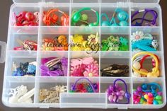 a plastic container filled with lots of different types of hair clips