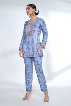 Blue short tunic style top with ikat motif geometric prints, scattered zari buttis and embroidered neckline and placet. Comes with coordinating printed pant. - Aza Fashions Blue Printed Palazzo Set For Festive Occasions, Festive Blue Printed Palazzo Set, Festive Printed Blue Palazzo Set, Blue Ikat Print Sets For Festivals, Fitted Cotton Ikat Print Sets, Blue Ikat Print Straight Kurta Set, Luxury Women's Ikat Print Sets, Festive Ikat Print Top, Multicolor Ikat Print Summer Sets