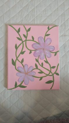 a painting of pink flowers with green leaves on a light pink square piece of paper