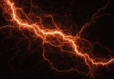 an image of lightning in the night sky with bright orange and yellow streaks on black background