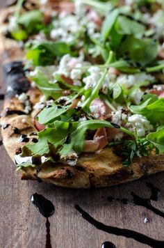 a close up of a pizza on a wooden table