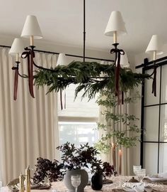 Christmas Decor Victorian House, Christmas Decoration For Dining Table, Christmas Greenery On Chandelier, Christmas Bows On Chandelier, Chandelier Dining Room Christmas Decor, Organic Modern Christmas Mantle, Christmas Decorations On Chandelier, Timeless Dining Room Decor, Chic Christmas Table Decor