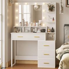 a white vanity with lights on it in a bedroom