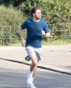 a man running in the street with headphones on