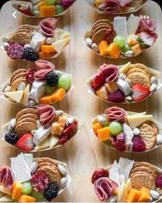 several bowls filled with different types of food on top of a wooden table next to each other