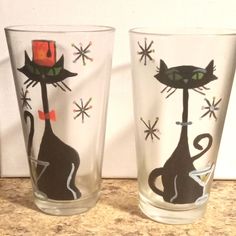 two glasses with black cats painted on them