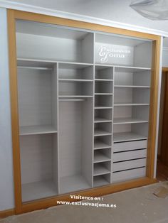 an empty walk in closet with shelves and drawers