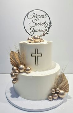 a white cake with gold decorations and a cross on top that says guest sandy glasig