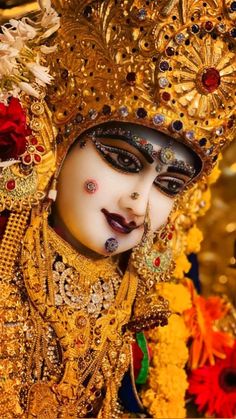 an elaborately decorated mask with flowers in the foreground