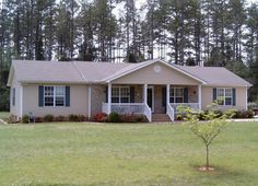 a house in the middle of some trees and grass