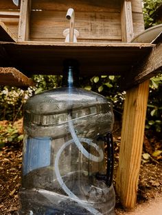 a plastic water bottle sitting under a bird house