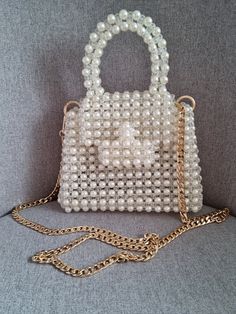 This luxurious beaded evening bag is handmade Bag made of round beads  COLOR White The versatile color will complement any outfit. Bead size 8*6 mm,  In the work, a fishing line 0.6 mm thick was used The fishing line provides a tight frame. The fishing line can withstand about 10 kg GOLD coloured hardware There is a button on the lid. There is a long handle 120 cm , silver colour, material stainless steel The chain can be removed if desired The bag can be carried in hand or over the shoulder. The bag holds a mobile phone, money, cosmetics, keys, wallet The bag is perfect for every day, as well as for a date, a wedding Every girl will be happy with such a gift. ! Product color may vary depending on screen settings.! Bag size Length 20 cm Width 6 cm Height 14 cm Luxury Pearl White Bags With Pearl Handle, White Pearl Handheld Bag, White Handheld Bag With Pearl Handle, Wedding Shoulder Bag With Pearl Handle, Rectangular, Luxury Bag With Pearl Handle, Rectangular Shape, Bride Tote Bag, Bride Tote, Bridal Bag, Crystal Bags