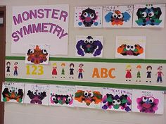 a bulletin board with monster and monsters on it in front of a door that says monster symmetry