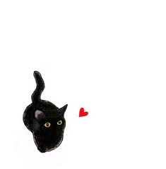 a black cat with yellow eyes looking up at a red heart in the sky above it