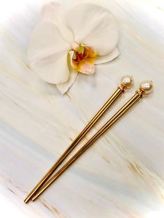 "Lovely Swarovski Pearls adorn the ends of these elegant hair sticks. Perfect for a wedding updo or bridal party gift. Our hair sticks have proven over the last 20 years to be the best on the market here's why: Strong, lightweight metal base sticks Approved for use in wet or damp hair All edges smoothed for a safe, snag free hold NO flimsy cheap head pins to bend our break No lead containing cheap imported spacer beads Genuine high quality jewelry grade gemstones Shown on our gold metal hair sti Hair Bun Pin, Jeweled Hair, Bridal Hair Pins Pearl, Bridal Hair Pin, Luxury Hair Accessories, Sweater Pin, Gold Hair Pin, Hair Jewels, Shawl Pin