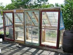 an old greenhouse is being worked on in the back yard