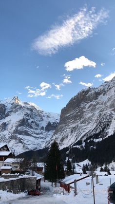 the mountains are covered in snow and clouds