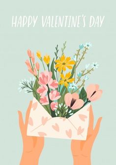 two hands holding an envelope with flowers in it that says happy valentine's day