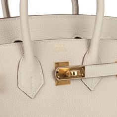 This Birkin is in Craie togo leather with gold hardware and has tonal stitching, two straps with front toggle closure, clochette with lock and two keys and double rolled handles.The interior is lined with Craie chevre and has one zip pocket with an Hermes engraved zipper pull and an open pocket on the opposite side.Collection: WOrigin: FranceCondition: New and never worn (plastic on hardware)Accompanied by: Hermes box, Hermes dustbag, clochette, lock, keys, clochette dustbag, felt, carebook, ribbonMeasurements: 10" width x 7.5" height x 4.75" depth; 2.75" handle drop Hermes Birkin 25, Hermes Box, Togo Leather, Birkin 25, Madison Avenue, Hermes Birkin, Gold Hardware, Zip Pockets, Dust Bag