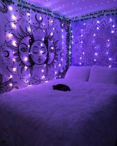 a cat is laying on a bed in a room decorated with lights