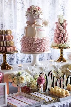 a table topped with lots of cakes and desserts