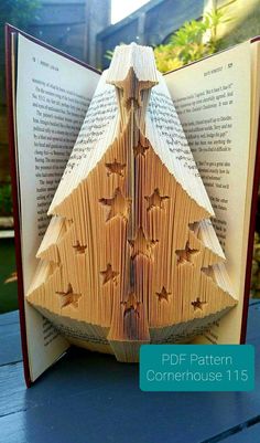 an origami christmas tree made out of book pages is shown in this image